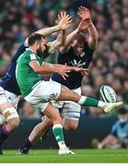 19 March 2022; Jamison Gibson Park of Ireland kicks under pressure from Josh Bayliss and Jonny Gray of Scotland during the Guinness Six Nations Rugby Championship match between Ireland and Scotland at Aviva Stadium in Dublin. Photo by Ramsey Cardy/Sportsfile