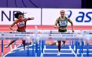 19 March 2022; Sarah Lavin of Ireland, right, competing in the women's 60m hurdles final, alongside Mujinga Kambundji of Switzerland, who fell, during day two of the World Indoor Athletics Championships at the Stark Arena in Belgrade, Serbia. Photo by Sam Barnes/Sportsfile