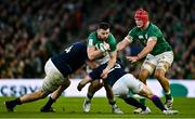 19 March 2022; Robbie Henshaw of Ireland is tackled by Jonny Gray and Mark Bennett of Scotland during the Guinness Six Nations Rugby Championship match between Ireland and Scotland at Aviva Stadium in Dublin. Photo by Brendan Moran/Sportsfile
