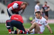 20 March 2022; Kieran Histon of Cork receives medical treatment before leaving the pitch with an injury during the Allianz Football League Division 2 match between Cork and Down at Páirc Uí Chaoimh in Cork. Photo by Brendan Moran/Sportsfile
