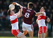 20 March 2022; Paul Kelly of Galway in action against Gareth McKinless and Ciaran McFaul of Derry during the Allianz Football League Division 2 match between Derry and Galway at Derry GAA Centre of Excellence in Owenbeg, Derry. Photo by Oliver McVeigh/Sportsfile