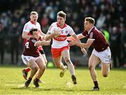 20 March 2022; Oisin McWilliams of Derry in action against Liam Silke and Dylan McHugh of Galway during the Allianz Football League Division 2 match between Derry and Galway at Derry GAA Centre of Excellence in Owenbeg, Derry. Photo by Oliver McVeigh/Sportsfile
