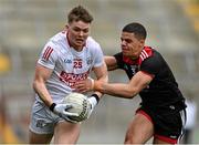 20 March 2022; Cathal O’Mahony of Cork is tackled by Finn McElroy of Down during the Allianz Football League Division 2 match between Cork and Down at Páirc Uí Chaoimh in Cork. Photo by Brendan Moran/Sportsfile