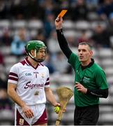 20 March 2022; Eanna Murphy of Galway receives a yellow card from referee James Owens during the Allianz Hurling League Division 1 Group A match between Galway and Clare at Pearse Stadium in Galway. Photo by Ray Ryan/Sportsfile