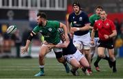 20 March 2022; Ben Carson of Ireland offloads as he is tackled by Mikey Jones of Scotland during the U20 Six Nations Rugby Championship match between Ireland and Scotland at Musgrave Park in Cork. Photo by Brendan Moran/Sportsfile