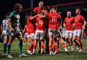 25 March 2022; Munster players celebrate after their first try, scored by Matt Gallagher, hidden, during the United Rugby Championship match between Munster and Benetton at Musgrave Park in Cork. Photo by Piaras Ó Mídheach/Sportsfile