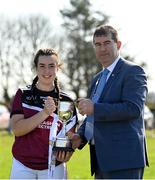 26 March 2022; Loreto College Cavan captain Aine Brady is presented the trophy by Uachtarán Cumann Peil Gael na mBan, Mícheál Naughton after the Lidl All Ireland Post Primary School Junior 'A' Championship Final match between Loreto College, Cavan, and Sacred Heart, Mayo, at Curry GAA club in Sligo. Photo by Harry Murphy/Sportsfile