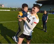 26 March 2022; Ryan Elliott of Antrim celebrates with his cousin Tadhg Donnelly, aged 3, from Dunloy, Co Antrim after the Allianz Hurling League Division 1 Relegation Play-off match between Antrim and Offaly at Páirc Tailteann in Navan, Meath. Photo by Daire Brennan/Sportsfile