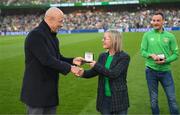 26 March 2022; Former Republic of Ireland player Paul McGrath makes a presentation to Olivia O'Toole at half-time of the international friendly match between Republic of Ireland and Belgium at the Aviva Stadium in Dublin. Photo by Stephen McCarthy/Sportsfile