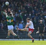 27 March 2022; Darragh Canavan of Tyrone kicks a point desoite the best efforts of Tom O’Sullivan of Kerry during the Allianz Football League Division 1 match between Kerry and Tyrone at Fitzgerald Stadium in Killarney, Kerry. Photo by Brendan Moran/Sportsfile
