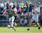 27 March 2022; James Carr of Mayo takes a shot on goal as Shea Ryan of Kildare closes in during the Allianz Football League Division 1 match between Mayo and Kildare at Avant Money Páirc Seán Mac Diarmada in Carrick-on-Shannon, Leitrim. Photo by Piaras Ó Mídheach/Sportsfile