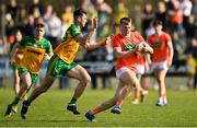 27 March 2022; Rian O'Neill of Armagh in action against Michael Langan of Donegal during the Allianz Football League Division 1 match between Donegal and Armagh at O'Donnell Park in Letterkenny, Donegal. Photo by Oliver McVeigh/Sportsfile