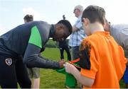 28 March 2022; Chiedozie Ogbene signs autographs for players from Mourne Celtic, Drimnagh, after a Republic of Ireland training session at FAI National Training Centre in Dublin. Photo by Eóin Noonan/Sportsfile