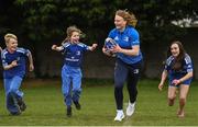 30 March 2022; In attendance at the launch of Leinster Rugby Summer Camps is Aoife Wafer of Leinster, second from right, with, from left, James Mullrooney, aged 10, Fiadh Bel Molloy, aged 9, and Holly O'Dell, aged 11,  at St Mary's College RFC in Dublin. Photo by Sam Barnes/Sportsfile