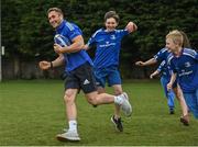 30 March 2022; In attendance at the launch of Leinster Rugby Summer Camps is Jordan Larmour of Leinster, left, with, from left, Kaleb McCallister, aged 12, and James Mullrooney, aged 11 at St Mary's College RFC in Dublin. Photo by Sam Barnes/Sportsfile
