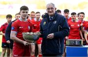 31 March 2022; Catholic University School captain Andrew Tonge is presented the trophy by Leinster Rugby president John Walsh after the Bank of Ireland Vinnie Murray Cup Final match between St Fintan's High School and Catholic University School at Energia Park in Dublin. Photo by Harry Murphy/Sportsfile
