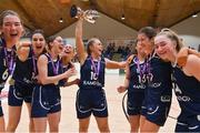 2 April 2022; Ulster University captain Aoife Callaghan and her teammates celebrate with the cup after the MissQuote.ie Division 1 League Cup Final match between NUIG Mystics, Galway and Ulster University, Antrim, at the National Basketball Arena in Dublin. Photo by Brendan Moran/Sportsfile