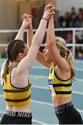 2 April 2022; Lucy-May Sleeman of Leevale AC, Cork, right, celebrates with a team-mate after winning the girls U19 4x200m relay during day three of the Irish Life Health National Juvenile Indoor Championships at TUS International Arena in Athlone, Westmeath. Photo by Sam Barnes/Sportsfile