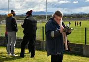 2 April 2022; A supporter reads the match programme before the Lidl All-Ireland PPS Senior A Final match between Moate Community School and St. Marys High School Midleton at Bruff GAA in Limerick. Photo by Diarmuid Greene/Sportsfile