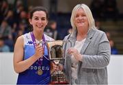 2 April 2022; Address UCC Glanmire team Áine McKenna is presented with the cup by Basketball Ireland WNLC chairperson Breda Dick after the MissQuote.ie Champions Trophy Final match between The Address UCC Glanmire, Cork and Singleton SuperValu Brunell, Cork, at the National Basketball Arena in Dublin. Photo by Brendan Moran/Sportsfile