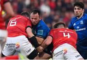 2 April 2022; Ed Byrne of Leinster is tackled by Peter O'Mahony and Jason Jenkins of Munster during the United Rugby Championship match between Munster and Leinster at Thomond Park in Limerick. Photo by Harry Murphy/Sportsfile