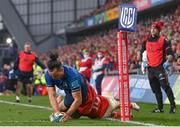 2 April 2022; James Lowe of Leinster  scores his side's second try despite the tackle of Calvin Nash of Munster during the United Rugby Championship match between Munster and Leinster at Thomond Park in Limerick. Photo by Harry Murphy/Sportsfile