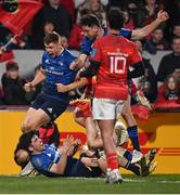 2 April 2022; Jimmy O'Brien of Leinster celebrates after scoring his side's third try with teammates Garry Ringrose and Hugo Keenan during the United Rugby Championship match between Munster and Leinster at Thomond Park in Limerick. Photo by Harry Murphy/Sportsfile