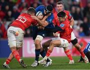 2 April 2022; Caelan Doris of Leinster is tackled by Alex Kendellen and Conor Murray of Munster during the United Rugby Championship match between Munster and Leinster at Thomond Park in Limerick. Photo by Harry Murphy/Sportsfile