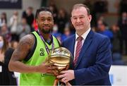 2 April 2022; Aaron Calixte of Garvey's Tralee Warriors is presented with the MVP by Basketball Ireland chief executive John Feehan after the InsureMyVan.ie SuperLeague Final match between Garvey’s Tralee Warriors, Kerry and C&S Neptune, Cork, at the National Basketball Arena in Dublin. Photo by Brendan Moran/Sportsfile