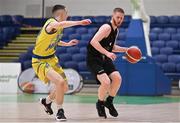 3 April 2022; Cillian O'Connell of Quish's Ballincollig in action against Ronan Byrne of UCD Marian during the InsureMyVan.ie U20 Men’s National League Final match between Quish's Ballincollig, Cork and UCD Marian, Dublin at the National Basketball Arena in Dublin. Photo by Brendan Moran/Sportsfile