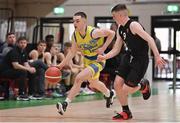 3 April 2022; Ronan Byrne of UCD Marian in action against Sean O'Flynn of Quish's Ballincollig during the InsureMyVan.ie U20 Men’s National League Final match between Quish's Ballincollig, Cork and UCD Marian, Dublin at the National Basketball Arena in Dublin. Photo by Brendan Moran/Sportsfile