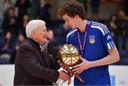 3 April 2022; Colm O'Reilly of UCD Marian presented with the MVP by Basketball Ireland board member Tony Burke after the InsureMyVan.ie U20 Men’s National League Final match between Quish's Ballincollig, Cork and UCD Marian, Dublin at the National Basketball Arena in Dublin. Photo by Brendan Moran/Sportsfile