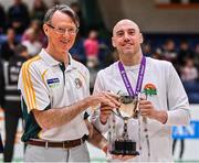 3 April 2022; Dublin Vikings captain Ian Durham is presented with the cup by Basketball Ireland masters committee member Paul Gallen after the InsureMyHouse.ie Masters Over 40’s Men National Cup Final match between Midlands Masters, Laois and Dublin Vikings at the National Basketball Arena in Dublin. Photo by Brendan Moran/Sportsfile