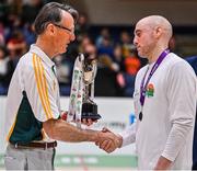 3 April 2022; Dublin Vikings captain Ian Durham is presented with the cup by Basketball Ireland masters committee member Paul Gallen after the InsureMyHouse.ie Masters Over 40’s Men National Cup Final match between Midlands Masters, Laois and Dublin Vikings at the National Basketball Arena in Dublin. Photo by Brendan Moran/Sportsfile