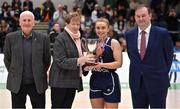 2 April 2022; Ulster University captain Aoife Callaghan is presented with the cup by Basketball Ireland WNLC member Annette O'Toole, in the company of Basketball Ireland board member Tony Burke, left, and Basketball Ireland chief executive John Feehan after  the MissQuote.ie Division 1 League Cup Final match between NUIG Mystics, Galway and Ulster University, Antrim, at the National Basketball Arena in Dublin. Photo by Brendan Moran/Sportsfile