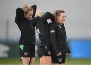 6 April 2022; Harriet Scott, right, Denise O'Sullivan and Megan Connolly, left, put in their GPS units before a Republic of Ireland women training session at the FAI National Training Centre in Abbotstown, Dublin. Photo by Stephen McCarthy/Sportsfile