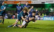 8 April 2022; Hugo Keenan of Leinster scores his side's third try despite the tackle of Cian Prendergast of Connacht during the Heineken Champions Cup Round of 16 first leg match between Connacht and Leinster at the Sportsground in Galway. Photo by Brendan Moran/Sportsfile