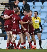 9 April 2022; Chris Farrell, right, and Mike Haley of Munster celebrate with try scorer Shane Daly after he scored their side's first try during the Heineken Champions Cup Round of 16 first leg match between Exeter Chiefs and Munster at Sandy Park in Exeter, England.  Photo by Harry Murphy/Sportsfile