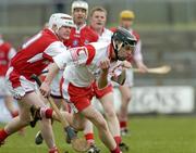28 March 2004; Joseph O'Neill, Tyrone, in action against Louth's Ger Collins. Allianz National Hurling League Division 3B, Round 5, Tyrone v Louth, Healy Park, Omagh, Co. Tyrone. Picture credit; Ray McManus / SPORTSFILE *EDI*