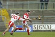 28 March 2004; Donach Callan, Louth, in action against Tyrone's Joseph O'Neill. Allianz National Hurling League Division 3B, Round 5, Tyrone v Louth, Healy Park, Omagh, Co. Tyrone. Picture credit; Ray McManus / SPORTSFILE *EDI*