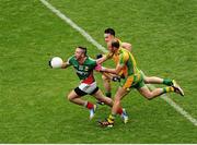 4 August 2013; Cathal Carolan, Mayo, in action against David Walsh, left, and Colm McFadden, Donegal. GAA Football All-Ireland Senior Championship, Quarter-Final, Mayo v Donegal, Croke Park, Dublin. Picture credit: Dáire Brennan / SPORTSFILE