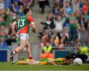 4 August 2013; Donegal's Ryan McHugh lies on the ground as Cillian O'Connor celebrates after scoring his third, and Mayo's fourth, goal. GAA Football All-Ireland Senior Championship, Quarter-Final, Mayo v Donegal, Croke Park, Dublin.  Picture credit: Ray McManus / SPORTSFILE