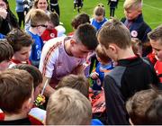 13 April 2022; Darragh Burns signs autographs for Easter Camp attendees during a meet and greet after a St Patrick's Athletic open training session at Richmond Park in Dublin. Photo by David Fitzgerald/Sportsfile
