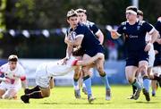 16 April 2022; Dylan O'Grady of UCD is tackled by Louis McDonough of Trinity during the Frazer McMullen all Ireland club U20 Rugby final match between UCD and Trinity at Lakelands Park, Terenure in Dublin. Photo by Ben McShane/Sportsfile