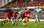 16 April 2022; Joey Carbery of Munster evades the tackle of Jonny Gray of Exeter Chiefs on his way to scoring his side's first try during the Heineken Champions Cup Round of 16 Second Leg match between Munster and Exeter Chiefs at Thomond Park in Limerick. Photo by Harry Murphy/Sportsfile