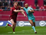 16 April 2022; Tom O'Flaherty of Exeter Chiefs is tackled by Chris Farrell of Munster during the Heineken Champions Cup Round of 16 Second Leg match between Munster and Exeter Chiefs at Thomond Park in Limerick. Photo by Brendan Moran/Sportsfile