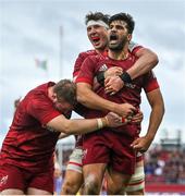 16 April 2022; Damian de Allende of Munster celebrates with teammates Stephen Archer and Thomas Ahern after scoring their side's second try during the Heineken Champions Cup Round of 16 Second Leg match between Munster and Exeter Chiefs at Thomond Park in Limerick. Photo by Brendan Moran/Sportsfile