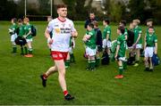 16 April 2022; Conor Meyler of Tyrone runs out past Fermanagh Cumann na mBunscol players before the Ulster GAA Football Senior Championship preliminary round match between Fermanagh and Tyrone at Brewster Park in Enniskillen, Fermanagh. Photo by Stephen McCarthy/Sportsfile