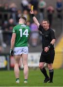 16 April 2022; Darragh McGurn of Fermanagh is shown a yellow card by referee Joe McQuillan during the Ulster GAA Football Senior Championship preliminary round match between Fermanagh and Tyrone at Brewster Park in Enniskillen, Fermanagh. Photo by Stephen McCarthy/Sportsfile