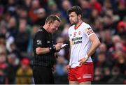 16 April 2022; Referee Joe McQuillan prepares to issue a yellow card to Conor McKenna of Tyrone during the Ulster GAA Football Senior Championship preliminary round match between Fermanagh and Tyrone at Brewster Park in Enniskillen, Fermanagh. Photo by Stephen McCarthy/Sportsfile